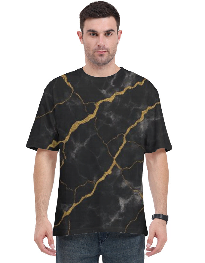 Man wearing a black t-shirt with gold marble pattern on a white background