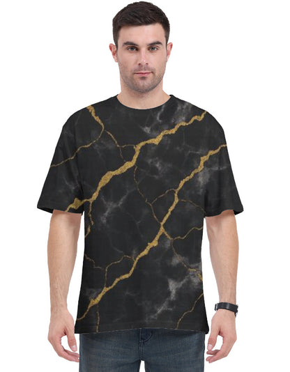 Man wearing a black t-shirt with gold marble pattern on a white background