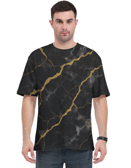 Man wearing a black t-shirt with gold marble pattern on a white background