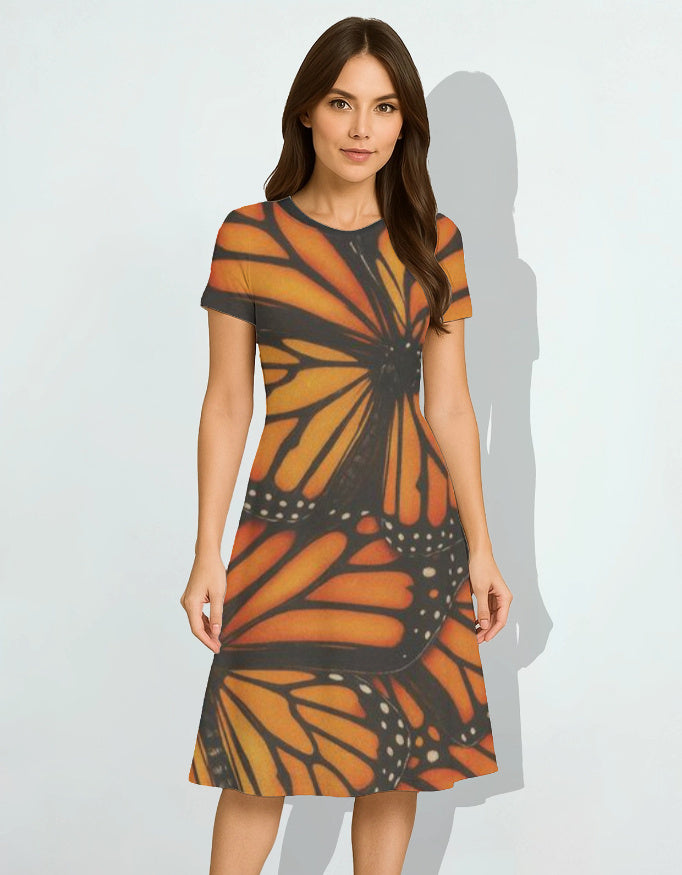 Woman wearing a dress with butterfly pattern on a plain background